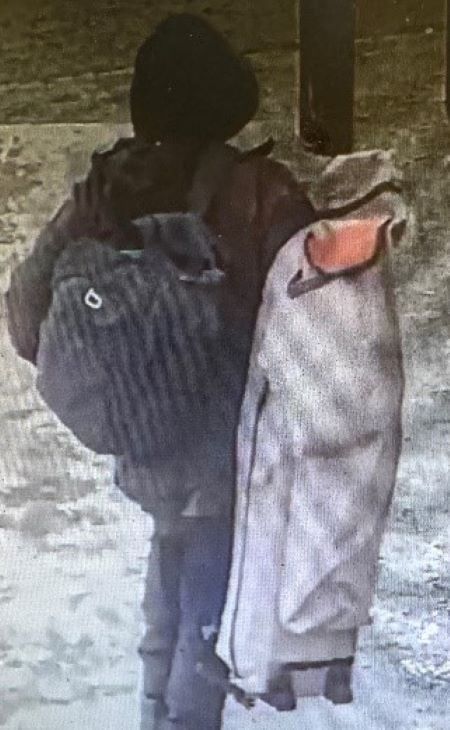 The suspect is described as male wearing all black, a hoodie with a white triangle over the forehead area, and a backpack. He was carrying a beige bag. 