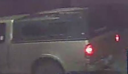 A dark canopy on the box of the truck. 