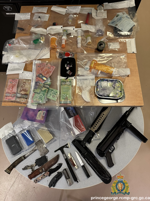 Photo of the drugs, weapons and other seized items