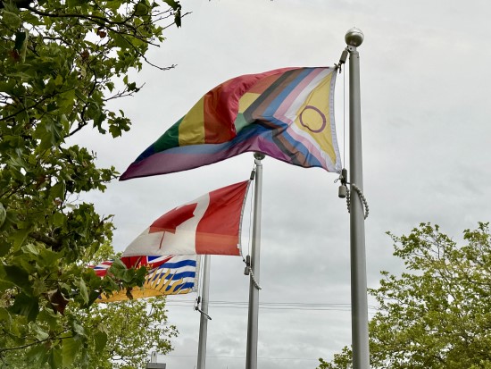 rainbow pride flag flown in front of Richmond RCMP detachment