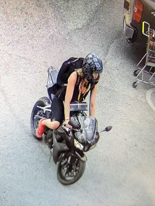 Video surveillance footage of female suspect and motorcycle.