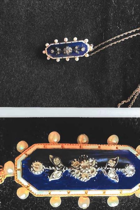 An image of the pendant attached to the gold chain. A close up of the pendant. 