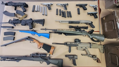 Seized firearms displayed on table
