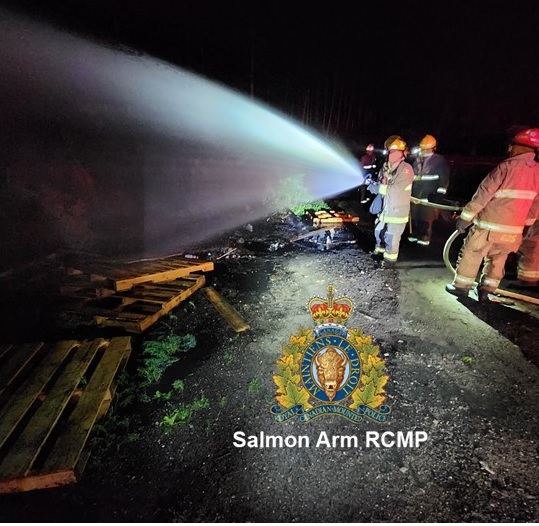 Fire department dousing fire with water