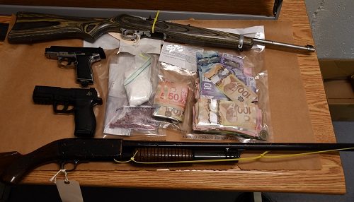 Seized drugs and weapons from executed warrant