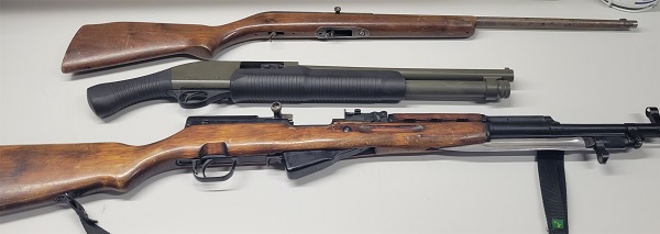 Three firearms displayed on table