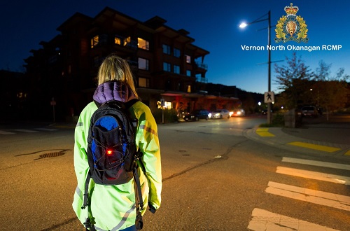 photo of person on road wearing reflective yellow coat