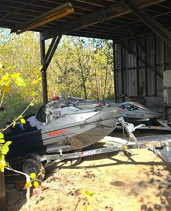 Photo of stolen Sea-Doos parked on an abandoned property