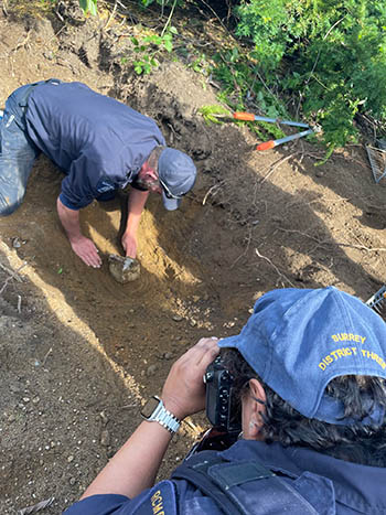 Members of the RCMP Forensic Identification Services locate the cremated remains.