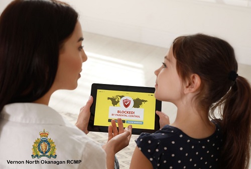 photo of mom and daughter holding tablet with blocked in text