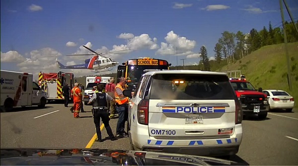 BC Highway Patrol and other first responders, including a medical helicopter, rescue the victims of a school bus crash near 100 Mile House.