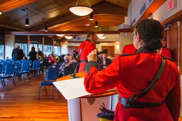 Inspector Veronica Fox adjusting the microphone on the podium at the beginning of the awards ceremony