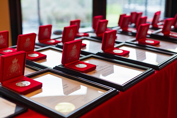 RCMP awards laying on a table with a red table cloth