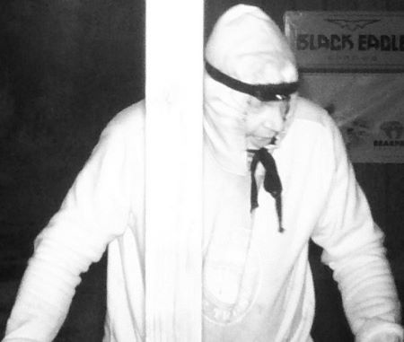 A woman with long hair in a hooded sweater with a skull on the foot.