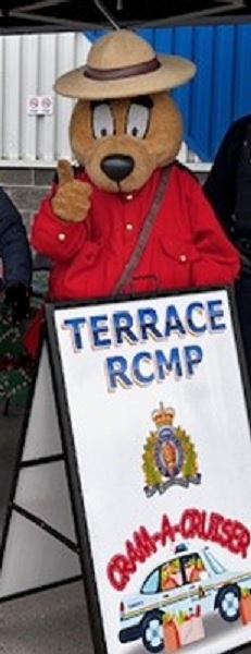 Safety Bear stands behind Cram a Cruiser sign