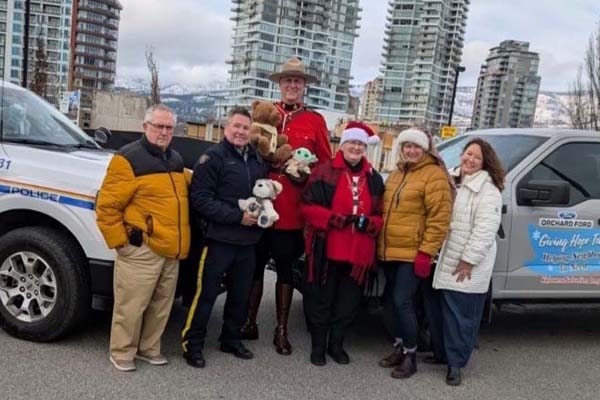 RCMP officers holding unwrapped toys for donation