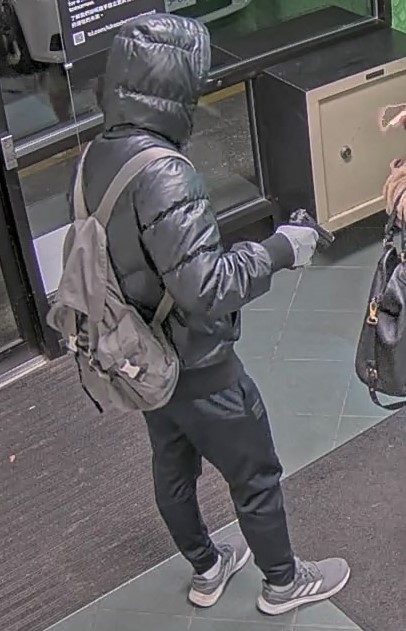 man wearing a backpack holding a gun