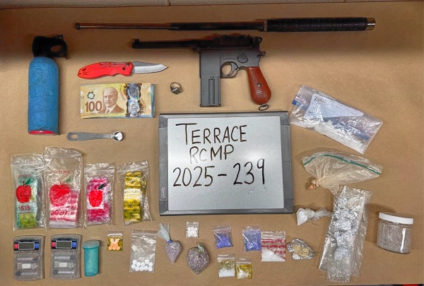 Display of weapons, drugs and drug trafficking items laid out on table