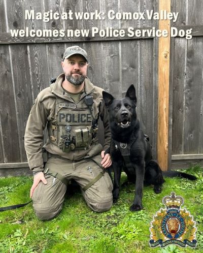 PSD Magic and Cst. Chris Johnson, sitting together in front of a fence