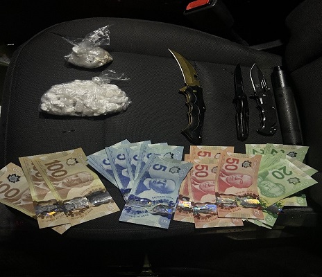 Picture of suspected drugs, monies, and weapons (knives)