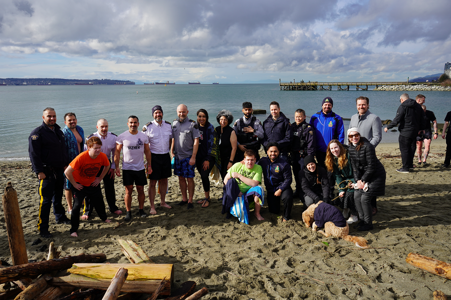 North Vancouver RCMP police officers, volunteers and Special Olympics BC athletes pose during the 2024 Polar Plunge event at Ambleside Beach in West Vancouver, BC.