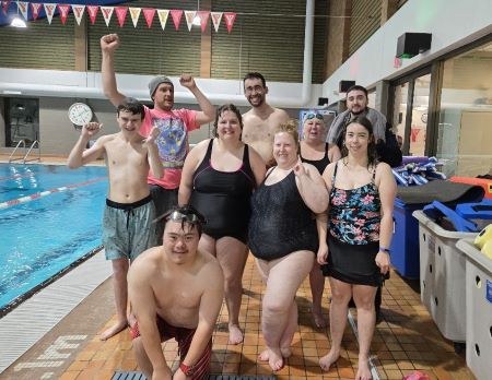 A group of swimmers pose with Cst. Nicoletti-Carriere (top back right) who will be supporting them in this year&rsquo;s Polar Plunge.