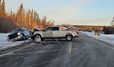 photo of a collision scene with a gold pickup truck blocking Hwy 97