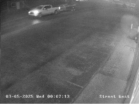 cctv photo of stolen trailer being towed by white truck 