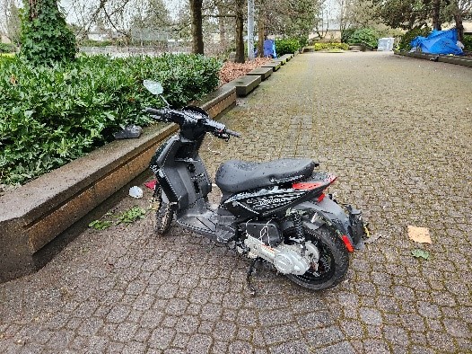 unregistered gas scooter in a public park with makeshift wiring