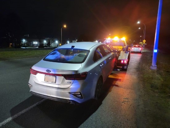 grey sedan on a tow truck