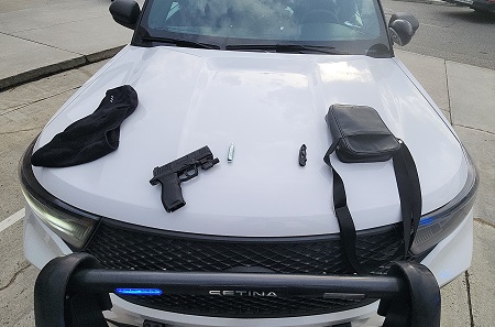 Photo of BB gun, knife, balaclava and small bag on police car