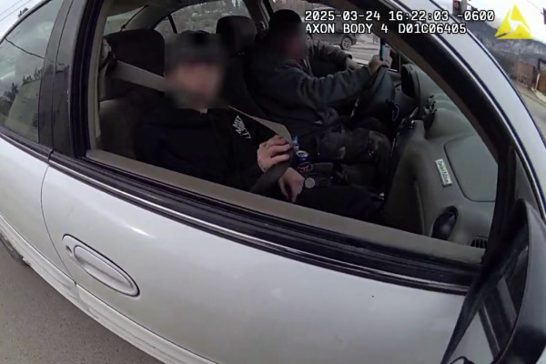 A police Body-Worn Camera captures a passenger trying a fasten her seatbelt after being stopped by BC Highway Patrol in Invermere, BC