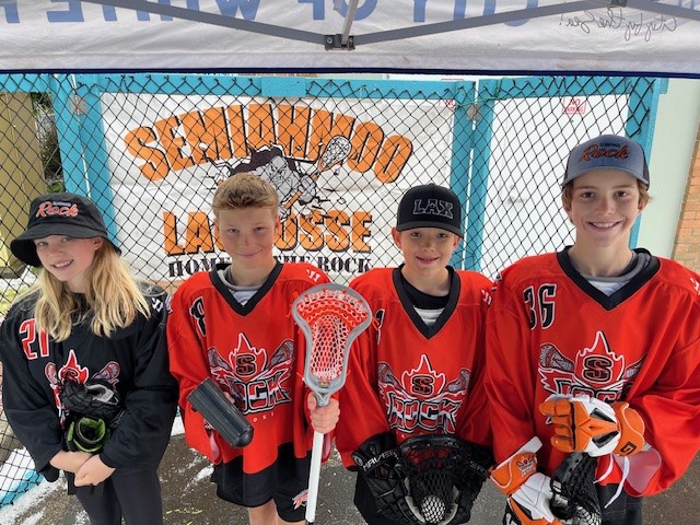 1 girl and 3 boy Semiahmoo Lacrosse players dressed in game uniform