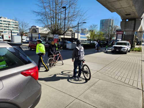 two Richmond RCMP officers standing on the sidewalk conducting enforcement