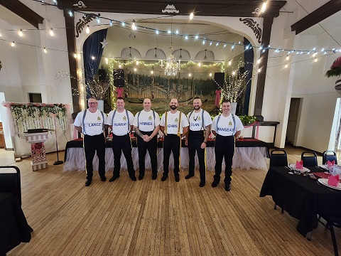 Detachment members in decorated community hall