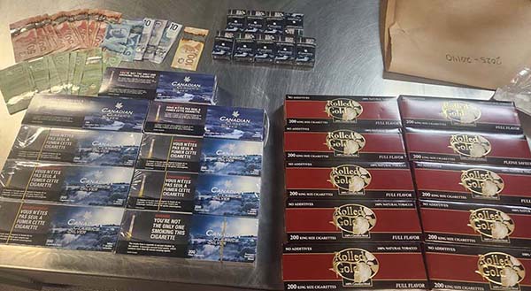 Table full of illicit tobacco and cash evidence 