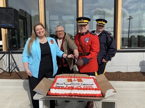Councillor Teri Forster, Mr. Murray Smith, D/Commr. Dwayne McDonald and Insp. Gerald Walker cutting the ceremonial cake with a sword