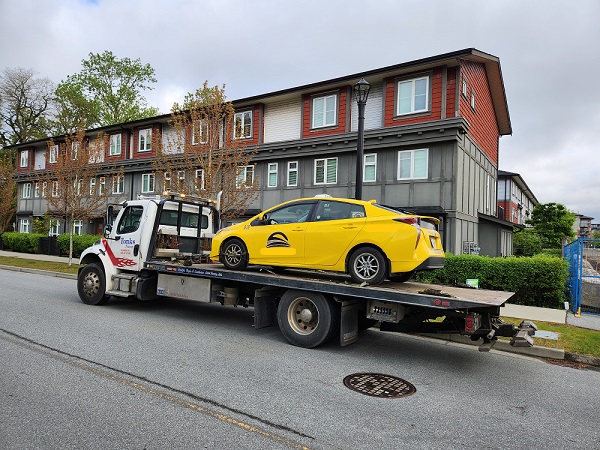 This taxi, on a flat-deck tow-truck, was impounded after a BC Highway Patrol officer determined the driver was impaired