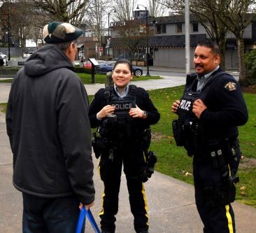 CRU officers speak with a resident at Memorial Peace Park 