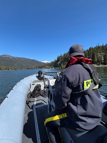 A photo of a RCMP Member operating a boat