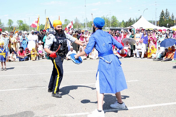 Photo of an RCMP member performing a traditional dance at the 2023 Vaisakhi parade