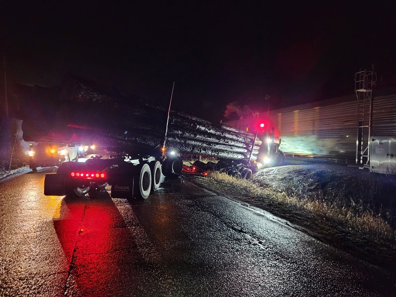 Semi truck in ditch, almost struck by train