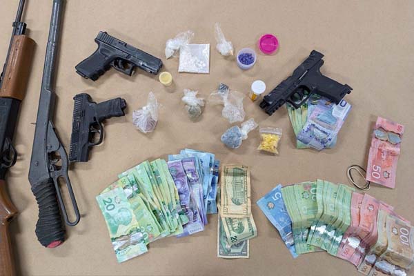 Photo of replica firearms, cash and drugs