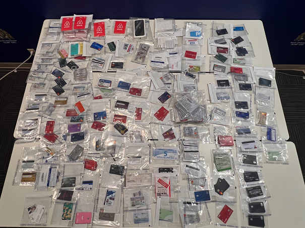 Picture of stolen credit cards and gift cards seized during police investigation