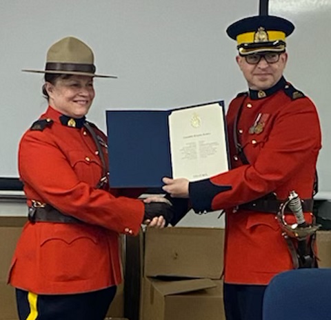 Komlos receives certificate from Inspector Gillespie