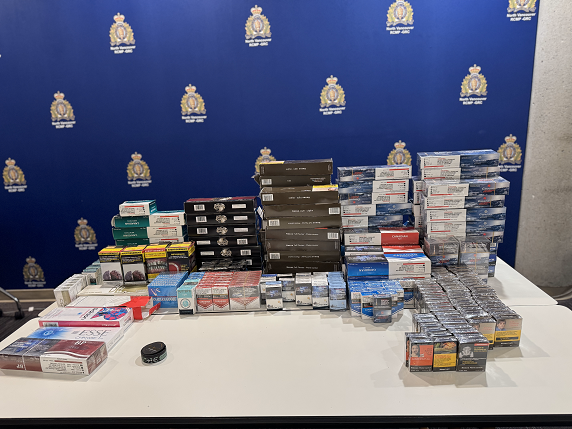 Collection of illicit tobacco products, including full cartons and single cartons, seized from a residence in the 700 block of West 20th Street on May 15, 2025.
