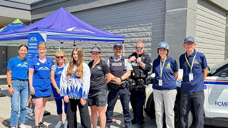 Group photo of Coquitlam RCMP Officers, staff, SHARE Society and Port Coquitlam/Ridge Meadows Ringette Association players
