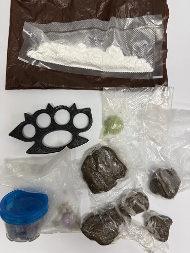 Suspected drugs and weapon