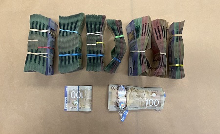 Seven large bundles of Canadian cash with two smaller bundles of Canadian cash.