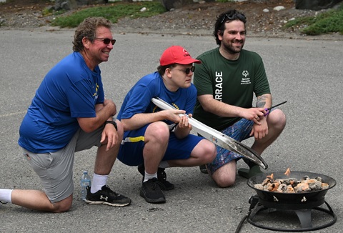 Torch run participants lighting the cauldron